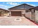 Home exterior showing a spacious two-car garage, paved driveway, and desert landscaping at 778 Dainty Daffodil St, Henderson, NV 89011