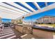 Outdoor grilling area with built-in grills, prep space, and a pergola for shade, ideal for summer barbecues at 778 Dainty Daffodil St, Henderson, NV 89011