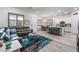 Open-concept living space featuring a comfortable couch and seamless flow to the kitchen at 778 Dainty Daffodil St, Henderson, NV 89011