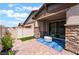Private outdoor patio with stone accents and stylish seating area at 778 Dainty Daffodil St, Henderson, NV 89011