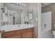 Bathroom featuring a wooden vanity with double sinks, a tub, and a shower at 7909 Citrus Meadow Ct, Las Vegas, NV 89131