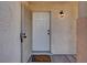 A welcoming front door with a 'Home Sweet Home' doormat and a stylish exterior light fixture at 7909 Citrus Meadow Ct, Las Vegas, NV 89131