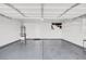 Spacious two-car garage featuring sealed concrete floors and built-in storage shelving at 7909 Citrus Meadow Ct, Las Vegas, NV 89131