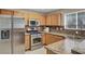 Modern kitchen with stainless steel appliances, granite countertops, and natural wood cabinetry at 7909 Citrus Meadow Ct, Las Vegas, NV 89131