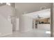 Bright and airy open floor plan showcasing the living area, staircase, and kitchen with stainless steel appliances at 7909 Citrus Meadow Ct, Las Vegas, NV 89131