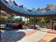 Colorful playground with climbing structures and tunnels, under a decorated canopy, offers fun and safe play areas at 7909 Citrus Meadow Ct, Las Vegas, NV 89131