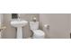 Compact half-bathroom with a pedestal sink, modern toilet, and simple decor at 7909 Citrus Meadow Ct, Las Vegas, NV 89131