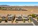 Aerial view of a quiet neighborhood featuring desert landscaping, single-Gathering homes, and mountain views in the background at 8013 Green River Knob St, Las Vegas, NV 89113