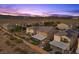 Sunset aerial view of a home featuring a private backyard, covered patio with hot tub, and desert landscaping at 8013 Green River Knob St, Las Vegas, NV 89113