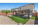 Spacious backyard with covered patio, hot tub, cozy seating, and landscaped areas, ideal for outdoor living at 8013 Green River Knob St, Las Vegas, NV 89113