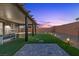 Picturesque backyard with covered patio, hot tub, lounge area, and manicured turf, perfect for relaxation and entertaining at 8013 Green River Knob St, Las Vegas, NV 89113