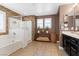 Beautiful bathroom with tiled floors, a stone accent wall, and dual sinks at 8013 Green River Knob St, Las Vegas, NV 89113