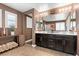 Stylish bathroom with double vanity, dark cabinetry, and decorative accents at 8013 Green River Knob St, Las Vegas, NV 89113
