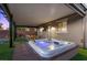 Backyard showcasing a hot tub beneath a covered patio with an outdoor seating area at 8013 Green River Knob St, Las Vegas, NV 89113