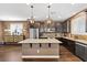 Spacious kitchen featuring a large island with stone countertop and stainless steel appliances at 8013 Green River Knob St, Las Vegas, NV 89113