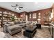 Cozy living room featuring a large sectional sofa, art and a book shelf at 8013 Green River Knob St, Las Vegas, NV 89113