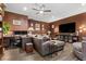 Cozy living room featuring a large sectional sofa and a dedicated workspace at 8013 Green River Knob St, Las Vegas, NV 89113