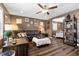 This cozy living room features hardwood floors, a ceiling fan, and lots of wall art at 8013 Green River Knob St, Las Vegas, NV 89113