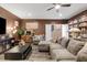 Spacious living room with designer touches like a book shelf and wood plank floors at 8013 Green River Knob St, Las Vegas, NV 89113