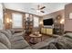 Cozy living room features a comfortable sectional, modern decor and wood plank floors at 8013 Green River Knob St, Las Vegas, NV 89113