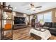 Inviting living room boasts wood floors, a flat screen TV, and plenty of storage at 8013 Green River Knob St, Las Vegas, NV 89113
