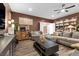 Spacious living room with designer touches like a book shelf and wood plank floors at 8013 Green River Knob St, Las Vegas, NV 89113