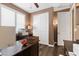 This office features hardwood floors, a printer, a closet, and brown walls at 8013 Green River Knob St, Las Vegas, NV 89113