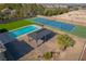 Aerial shot of a backyard featuring a pool, gazebo, tennis court, and lush landscaping at 8228 Fulton Ranch St, Las Vegas, NV 89131