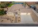 Aerial view of a single-story house featuring three-car garage, solar panels, and large backyard with tennis court at 8228 Fulton Ranch St, Las Vegas, NV 89131