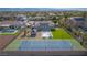 Expansive view of backyard paradise, with a pool, tennis court, gazebo, and lush landscaping at 8228 Fulton Ranch St, Las Vegas, NV 89131