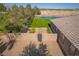 Aerial view of backyard showing tennis court, artificial grass, block wall, brick path, and rock ground covering at 8228 Fulton Ranch St, Las Vegas, NV 89131