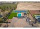 Aerial view showcases a sparkling pool, tennis court, green space, and well-maintained desert landscaping at 8228 Fulton Ranch St, Las Vegas, NV 89131