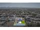 Aerial view showcases a sparkling pool, tennis court, green space, desert landscaping, and mountain views at 8228 Fulton Ranch St, Las Vegas, NV 89131