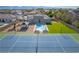 Aerial view showcases a home with a pool, gazebo, tennis court, and lush green lawn at 8228 Fulton Ranch St, Las Vegas, NV 89131