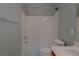 Bathroom with tub shower, white fixtures, and gray walls at 8228 Fulton Ranch St, Las Vegas, NV 89131