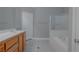 This is a bathroom with tile flooring, a tub, shower, and cabinets with a white countertop at 8228 Fulton Ranch St, Las Vegas, NV 89131