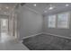 Comfortable bedroom offers neutral walls, carpet, ceiling fan, and bright shuttered windows at 8228 Fulton Ranch St, Las Vegas, NV 89131