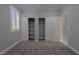 Bright bedroom features gray carpet, closet with shelves, and neutral paint at 8228 Fulton Ranch St, Las Vegas, NV 89131