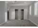 This bedroom features an open closet space, carpet, and shuttered windows at 8228 Fulton Ranch St, Las Vegas, NV 89131