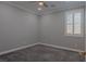 Cozy bedroom with ceiling fan, neutral walls and carpet, plus bright shuttered window at 8228 Fulton Ranch St, Las Vegas, NV 89131