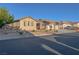 Inviting single-story home with desert landscaping, three-car garage, and a well-maintained front yard at 8228 Fulton Ranch St, Las Vegas, NV 89131