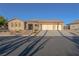 Attractive single-story home featuring a three-car garage, desert landscaping, and a welcoming entrance at 8228 Fulton Ranch St, Las Vegas, NV 89131