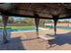 Gazebo featuring lights, drapes and a table alongside artificial grass, tennis court, and pool at 8228 Fulton Ranch St, Las Vegas, NV 89131