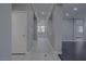 Well-lit hallway with tile flooring, neutral paint, and views into adjacent living spaces at 8228 Fulton Ranch St, Las Vegas, NV 89131