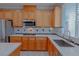 Bright kitchen featuring stainless steel appliances, granite countertops, and oak cabinetry at 8228 Fulton Ranch St, Las Vegas, NV 89131