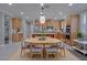 Open kitchen and dining area with updated cabinetry, stainless steel appliances, and eat-in kitchen island at 8228 Fulton Ranch St, Las Vegas, NV 89131