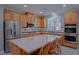Open kitchen features a large island and stainless steel appliances at 8228 Fulton Ranch St, Las Vegas, NV 89131