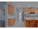 Kitchen view of a stainless fridge and a large island with seating at 8228 Fulton Ranch St, Las Vegas, NV 89131