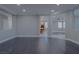 Open-concept living room with dark wood-look flooring, neutral walls, and generous natural light at 8228 Fulton Ranch St, Las Vegas, NV 89131