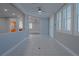 Open concept living space with tile floors, neutral walls and bright shuttered windows at 8228 Fulton Ranch St, Las Vegas, NV 89131